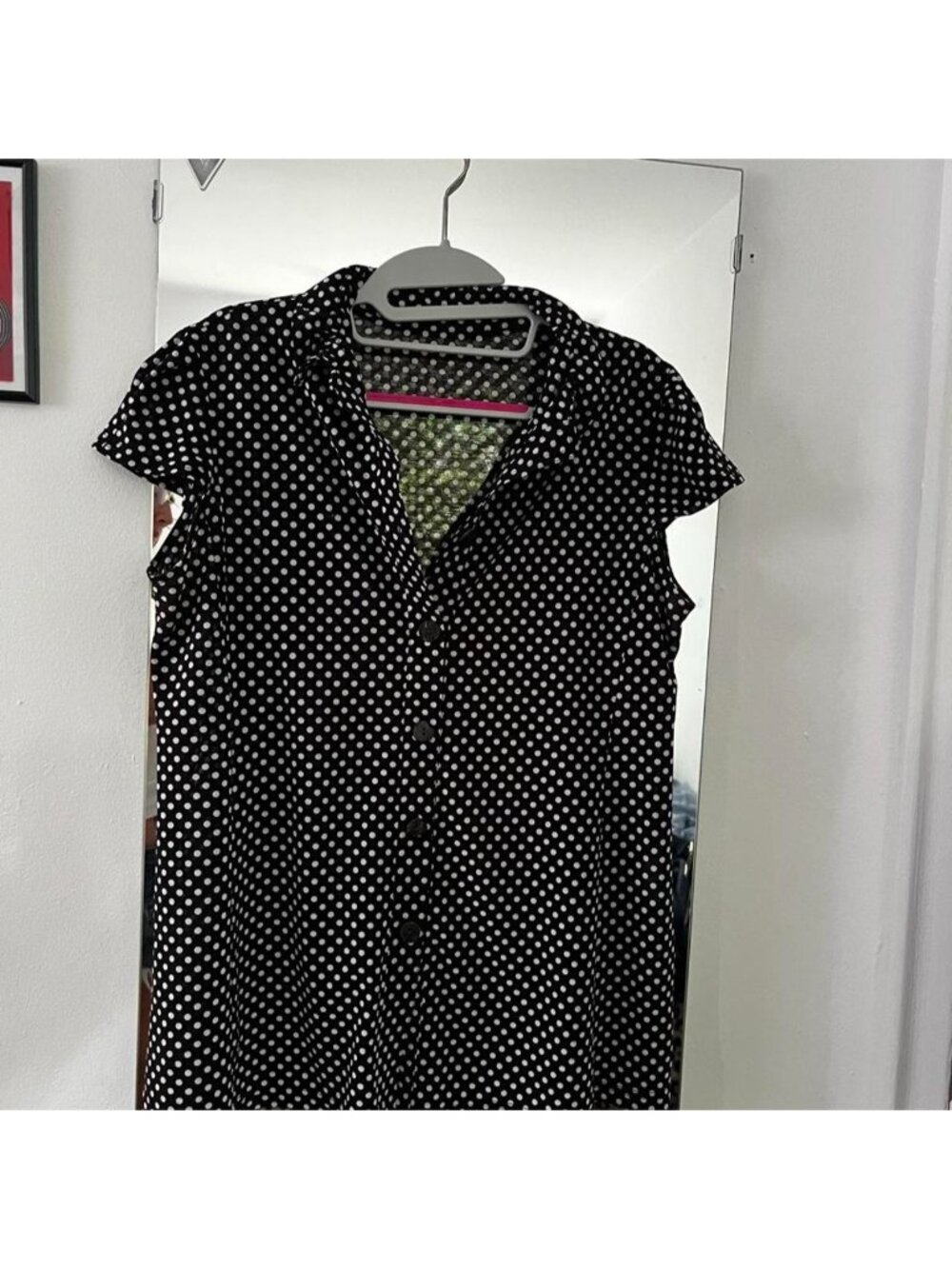Black and white polka dot blouse with button-up front.